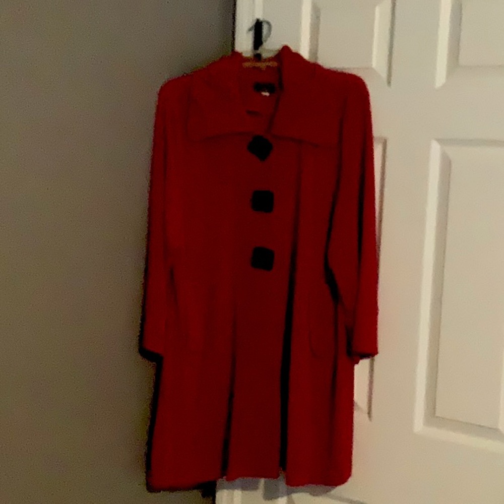 Like new. Red jacket with black chunky buttons.